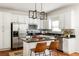 Modern kitchen featuring white cabinets, stainless steel appliances, an island with bar seating, and sleek countertops at 513 Boulevard Se, Atlanta, GA 30312