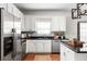 Bright kitchen featuring white cabinets, stainless steel appliances, granite countertops, and a stylish backsplash at 513 Boulevard Se, Atlanta, GA 30312