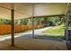 Covered back patio with a view of the grassy lawn, mature trees and wooded fence line at 513 Boulevard Se, Atlanta, GA 30312
