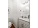 Cozy powder room featuring a round mirror, elegant vanity, and modern lighting at 513 Boulevard Se, Atlanta, GA 30312