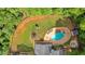 Aerial view of a private backyard with a pool, firepit, swing set, and trampoline at 1421 Hendon Rd, Woodstock, GA 30188