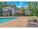 Backyard with a large pool, surrounded by lush landscaping and outdoor seating areas at 1421 Hendon Rd, Woodstock, GA 30188