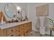 Bathroom with double sinks, granite countertops, and rustic wood cabinets at 1421 Hendon Rd, Woodstock, GA 30188
