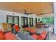Spacious covered patio with seating and dining areas, featuring a wooden ceiling with ceiling fans at 1421 Hendon Rd, Woodstock, GA 30188