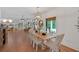 Bright dining room with hardwood floors, stylish light fixture, a wood table with seating for eight at 1421 Hendon Rd, Woodstock, GA 30188