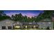 Stunning exterior elevation of home at dusk with meticulous landscaping and charming front porch at 1421 Hendon Rd, Woodstock, GA 30188
