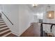 Bright hallway features hardwood floors, white walls, stairs, and subtle decor at 1421 Hendon Rd, Woodstock, GA 30188
