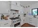 Gourmet kitchen with stainless steel appliances, white cabinetry, stylish backsplash, and lots of natural light at 1421 Hendon Rd, Woodstock, GA 30188