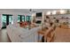 Open-concept living room with ample seating, fireplace, and lots of natural light at 1421 Hendon Rd, Woodstock, GA 30188