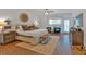 Spacious main bedroom features hardwood floors, a ceiling fan, a sitting area, and a large area rug at 1421 Hendon Rd, Woodstock, GA 30188