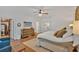 Bright main bedroom features hardwood floors, large bed with decorative pillows, and a dresser at 1421 Hendon Rd, Woodstock, GA 30188