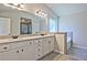 Bathroom with granite countertops, white cabinets, gray tile flooring, and a view of the bathtub and shower at 238 Linford Dr, Locust Grove, GA 30248