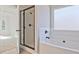 Bathroom featuring a glass shower door, soaking tub, and white subway tile surround at 238 Linford Dr, Locust Grove, GA 30248