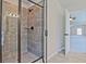 Modern bathroom featuring a glass-enclosed shower with gray tile and view to an adjoining room at 238 Linford Dr, Locust Grove, GA 30248