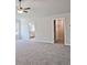 Large carpeted bedroom featuring a door leading into a bathroom and a closet at 238 Linford Dr, Locust Grove, GA 30248