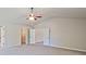 Large carpeted bedroom featuring two entry doors; one to a closet and another to the bathroom at 238 Linford Dr, Locust Grove, GA 30248