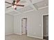Spacious bedroom featuring a ceiling fan and decorative tray ceiling at 238 Linford Dr, Locust Grove, GA 30248