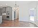 Open dining space with stylish lighting, kitchen access, and backyard views at 238 Linford Dr, Locust Grove, GA 30248