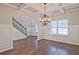 Dining area boasting hardwood floors, coffered ceilings, wainscoting, and stairs to the second floor at 238 Linford Dr, Locust Grove, GA 30248