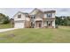 Charming two-story home featuring brick and white siding, a two-car garage, and a well-manicured lawn at 238 Linford Dr, Locust Grove, GA 30248