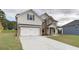 Inviting two-story home showcasing brick and siding, a manicured lawn, and a two-car garage at 238 Linford Dr, Locust Grove, GA 30248