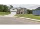 Inviting two-story home showcasing a manicured lawn, brick accents, and a convenient two-car garage at 238 Linford Dr, Locust Grove, GA 30248