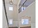 Open foyer boasting soaring ceilings, a second-story balcony, wainscoting, and large windows at 238 Linford Dr, Locust Grove, GA 30248