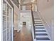 Grand foyer featuring hardwood floors, staircase, and an open view to the living area with fireplace at 238 Linford Dr, Locust Grove, GA 30248