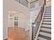Elegant foyer featuring hardwood floors, wainscoting, a chandelier, and a view to the kitchen at 238 Linford Dr, Locust Grove, GA 30248