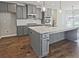 Stylish kitchen featuring granite countertops, stainless steel appliances, and gray cabinets at 238 Linford Dr, Locust Grove, GA 30248