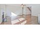 Bright, open-concept living room featuring hardwood floors and a cozy fireplace at 238 Linford Dr, Locust Grove, GA 30248