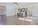 Open-concept living space with hardwood floors and a view of the modern kitchen at 238 Linford Dr, Locust Grove, GA 30248
