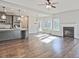 Open-concept living room with hardwood floors, fireplace, lots of light and view into the kitchen at 238 Linford Dr, Locust Grove, GA 30248