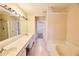 Bathroom features a double vanity, tub, and separate access to the walk in closet at 3601 Gainesway Trce, Duluth, GA 30096