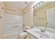 Bright bathroom with tub and shower combination, white vanity, and a large mirror at 3601 Gainesway Trce, Duluth, GA 30096