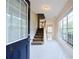 Inviting foyer with white tile flooring, staircase, and large windows allowing ample natural light at 3601 Gainesway Trce, Duluth, GA 30096