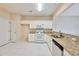 Bright kitchen featuring white cabinets, granite countertops, and essential appliances for efficient cooking at 3601 Gainesway Trce, Duluth, GA 30096