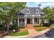 Inviting clubhouse featuring a covered porch, brick pathway, and manicured landscaping at 4676 Ivygate Se Cir, Atlanta, GA 30339