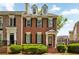 Charming brick townhome with well-maintained landscaping, black shutters, and a welcoming entrance at 4676 Ivygate Se Cir, Atlanta, GA 30339