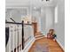 Bright hallway with hardwood floors, chair rail detail, and a view of the staircase at 4676 Ivygate Se Cir, Atlanta, GA 30339