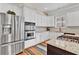 Bright kitchen features white cabinets, stainless appliances, double oven, granite countertops, and hardwood floors at 4676 Ivygate Se Cir, Atlanta, GA 30339