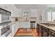 Bright kitchen showcases white cabinets, stainless appliances, granite countertops, and hardwood floors at 4676 Ivygate Se Cir, Atlanta, GA 30339