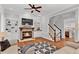 Open-concept living room with hardwood floors, fireplace, and staircase at 4676 Ivygate Se Cir, Atlanta, GA 30339