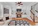 Cozy living room featuring a fireplace with built-in shelves and hardwood floors at 4676 Ivygate Se Cir, Atlanta, GA 30339