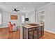 Living room with hardwood floors flows from kitchen with central island and stainless gas cooktop at 4676 Ivygate Se Cir, Atlanta, GA 30339