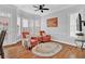 Sun-filled living room featuring hardwood floors, two orange chairs, and many windows at 4676 Ivygate Se Cir, Atlanta, GA 30339