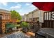 Outdoor patio with a table and chairs overlooks the back of the building and features a small garden at 4676 Ivygate Se Cir, Atlanta, GA 30339