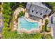Aerial view of a community pool surrounded by lush greenery and lounge chairs on a sunny day at 4676 Ivygate Se Cir, Atlanta, GA 30339
