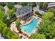 Community pool with lounge chairs and seating area surrounded by lush greenery and a clubhouse at 4676 Ivygate Se Cir, Atlanta, GA 30339