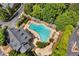 Aerial view of a community pool with lounge chairs and lush landscaping at 4676 Ivygate Se Cir, Atlanta, GA 30339